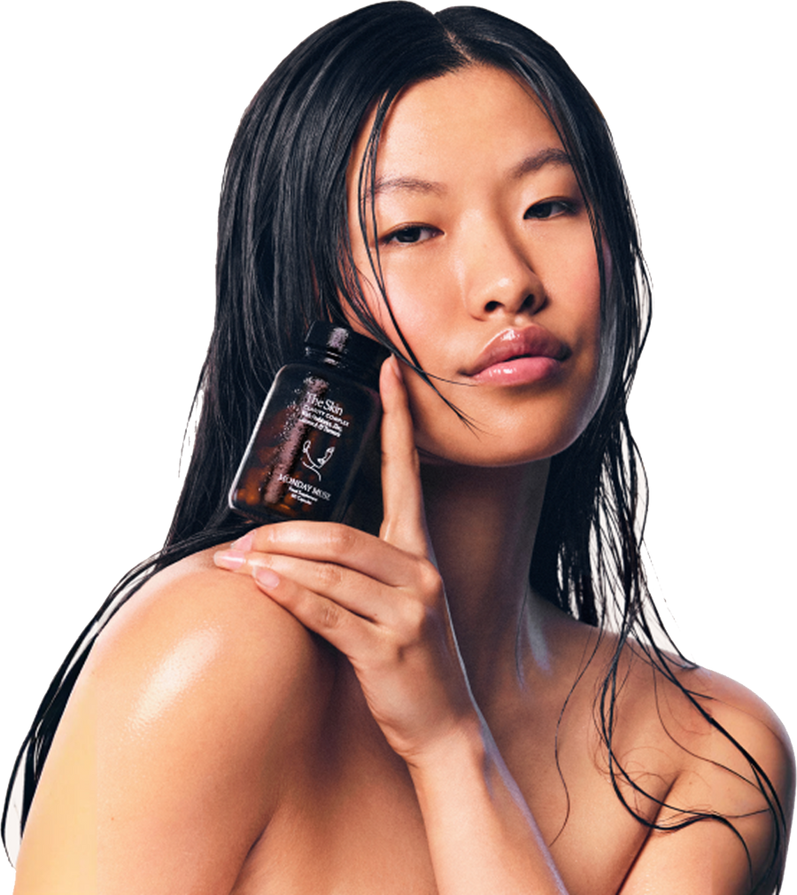 Woman holding The Skin Clarity Complex bottle